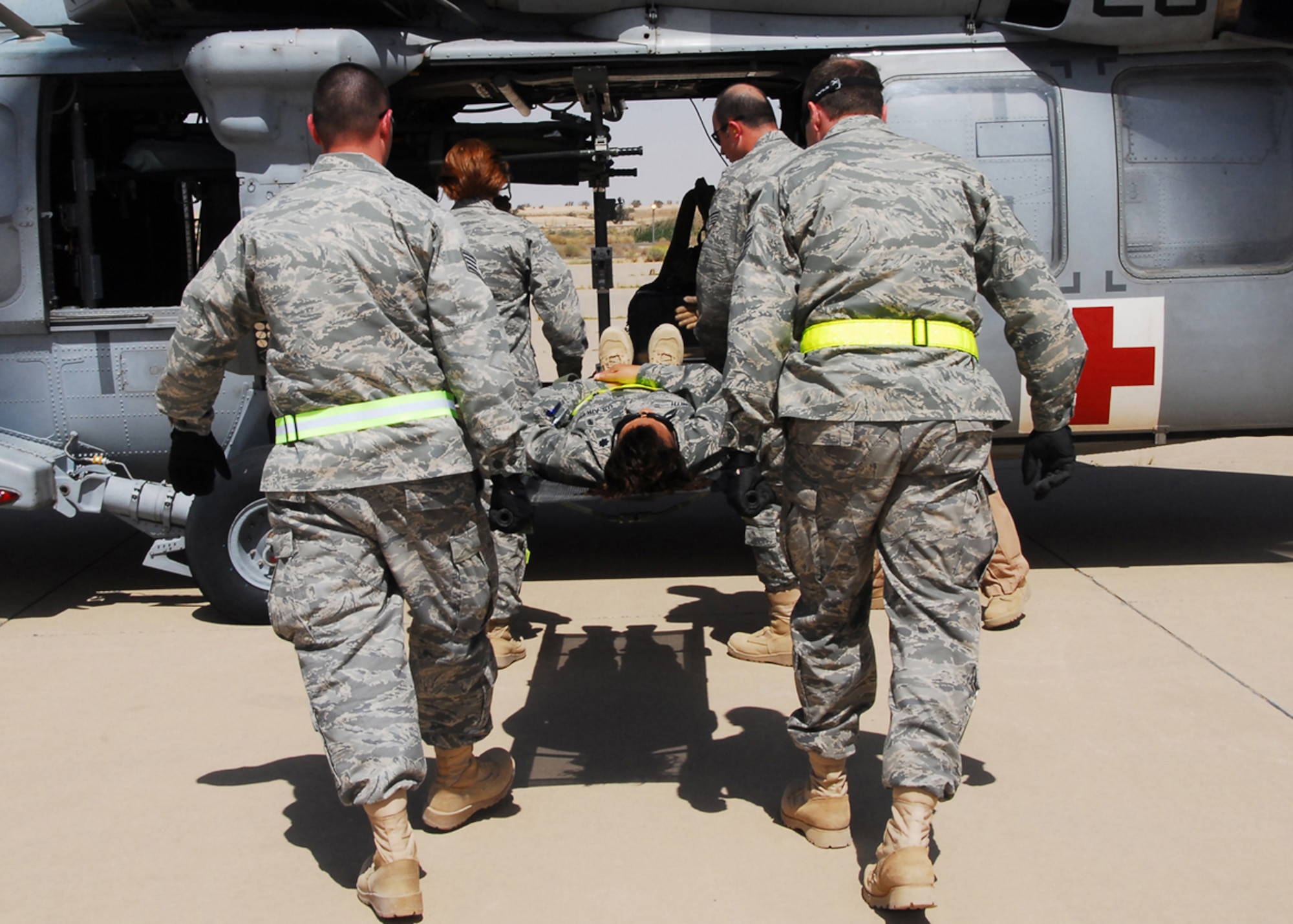 SOUTHWEST ASIA -- Airmen from the 386th Expeditionary Medical Group load a litter on a Navy medical helicopter, 2515th Naval Air Ambulance, from an Army base in Southwest Asia during Litter Management System Training at an air base in Southwest Asia, March 20. The purpose of the training was to help the 386th EMDG to better understand proper procedures when loading and unloading patients onto a Naval medevac helicopter. (U.S. Air Force photo/ Senior Airman Courtney Richardson)