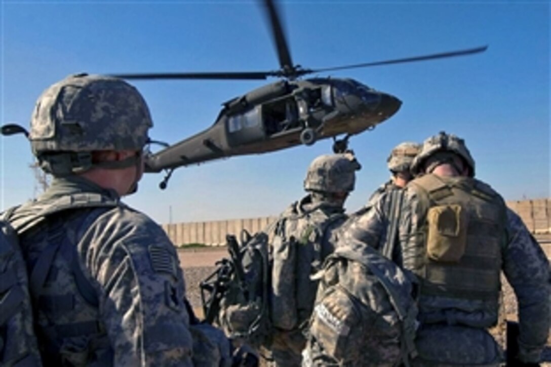 U.S. Army soldiers prepare to board a UH-60 Black Hawk helicopter landing to pick them up and transport them to an area south of Balad Ruz, Iraq, March 22, 2009. The soldiers are assigned to the 25th Infantry Division's Recon Platoon, 1st Battalion, 24th Infantry Regiment, 1st Stryker Brigade Combat Team.