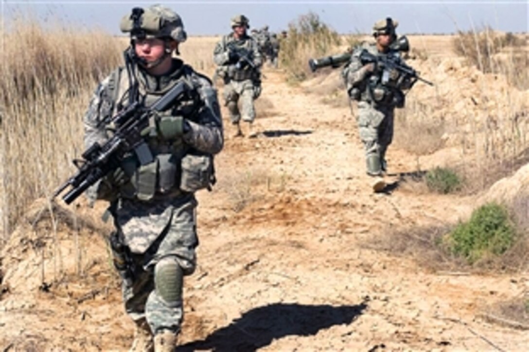 U.S. Army Sgt. Cory Carnes, left, leads a patrol while they search for enemy bunkers south of Balad Ruz, Iraq, March 22, 2009. The soldiers are assigned to the 25th Infantry Division's 1st Battalion, 24th Infantry Regiment, 1st Stryker Brigade Combat Team.