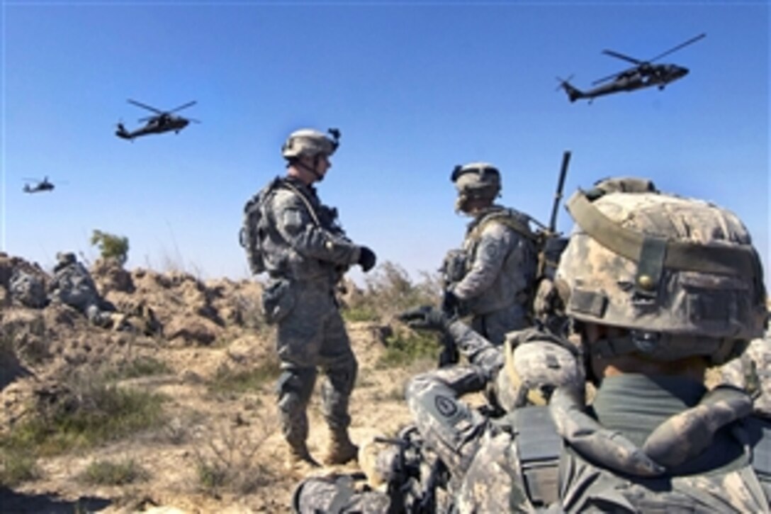 U.S. Army soldiers wait to be picked up by UH-60 Black Hawk helicopters south of Balad Ruz, Iraq, March 22, 2009. The soldiers are assigned to the 25th Infantry Division's 1st Battalion, 24th Infantry Regiment, 1st Stryker Brigade Combat Team.