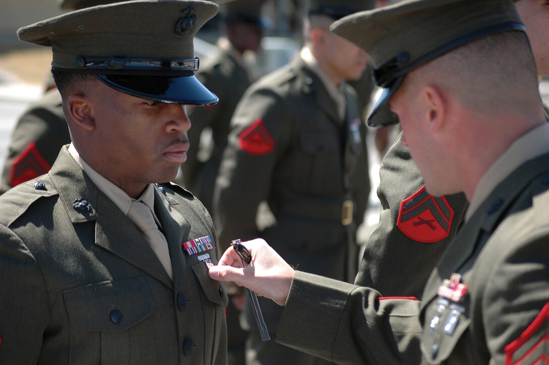 Staff Sgt. Dale Wojtowicz inspects a Headquarters and Headquarters Squadron Marine in his service alpha uniform during a uniform inspection at the Marine Corps Air Station in Yuma, Ariz., March 24. The inspection was held to prepare the Marines for an official command inspection the following week.