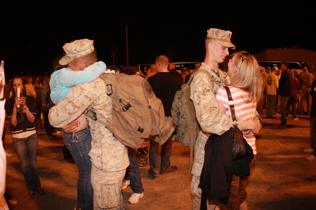 Marines with 3rd Battalion, 7th Marine Regiment kiss and hug their loved ones after returning from deployment. The battalion returned to the Combat Center March 25 from their support of Operation Iraqi Freedom.