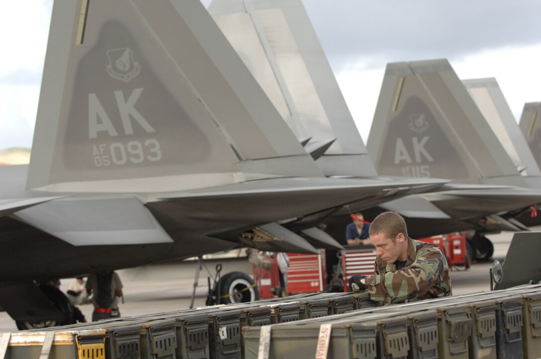 Airman 1st Class Colin Meyer, munitions specialist straps down a flare trailer March 19 at Andersen Air Force Base, Guam during exercise Jungle Shield. The exercise will help ensure U.S. forces are well prepared to conduct important homeland defense missions. The F-22 Raptors are deployed from Elmendorf Air Force Base, Alaska, to Guam for three months as the Pacific's Theater Security Package. (U.S. Air Force photo/ Master Sgt. Kevin J. Gruenwald) released      