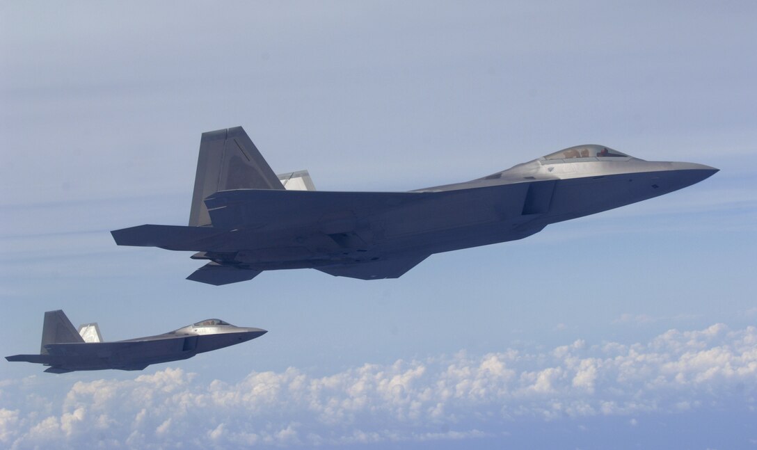 Two F-22 Raptors fly over the Pacific Ocean after a refueling mission during a training exercise March 18. The Raptors are deployed from Elmendorf Air Force Base, Alaska to the 90th Expeditionary Fighter Squadron Andersen Air Force Base, Guam. Fourteen of the $140 million dollar aircraft, and more than 250 Airmen have been here since January for a three month deployment as the Pacific's Theater Security Package. The stealth-fighters, along with associated maintenance and support personnel will participate in various exercises that provide routine training in an environment different from their home station. 

(U.S. Air Force photo/ Master Sgt. Kevin J. Gruenwald) released

