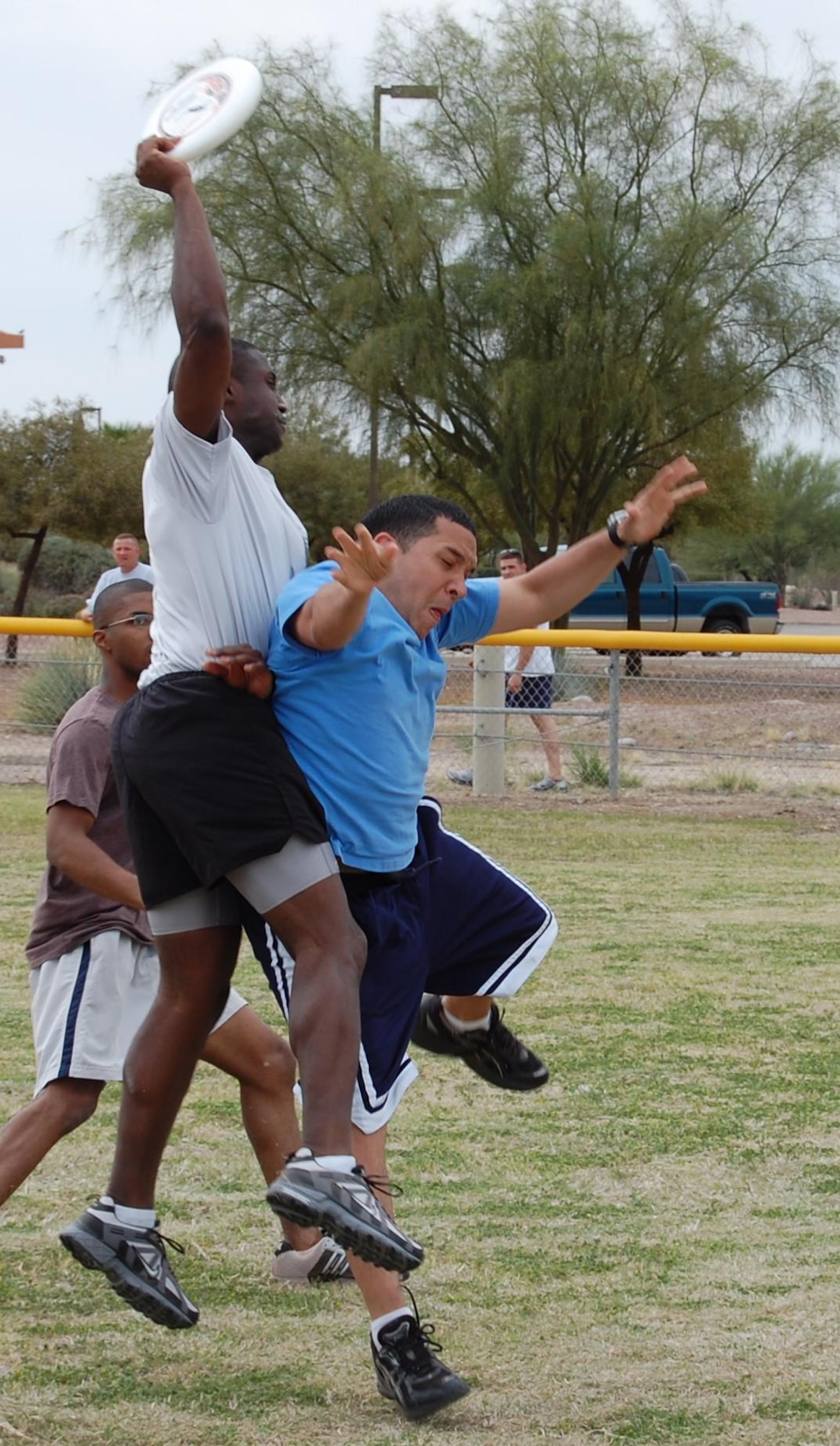 DAVIS-MONTHAN AIR FORCE BASE, Ariz. --  Senior Airman Raphael Mirabal-Lugo, 612th Air and Space Operations Center imagery analyst tries to block Sergeant First Class Kenneth Blackmon, 1st Battlefield Coordination Detachment, during the ultimate Frisbee portion of 12th Air Force (Air Forces Southern) sports day March 20. More than 200 members of 12th AF competed in the event. (U.S. Air Force photo by 1st Lt. Jason Coley) 
