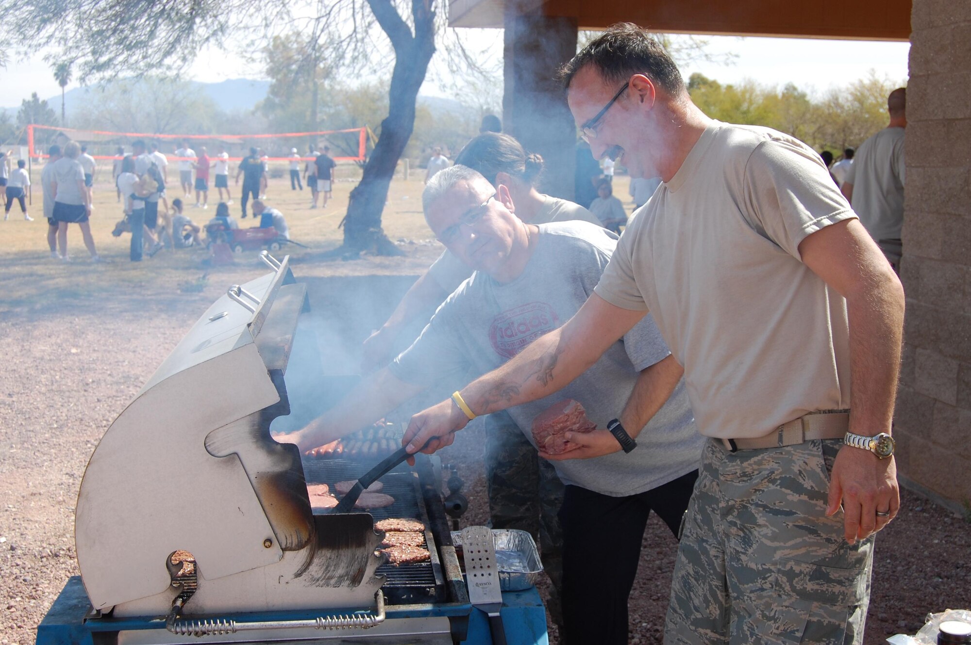 DAVIS-MONTHAN AIR FORCE BASE, Ariz. --  Master Sgt. Cesar Medina (Right), 612th Air and Space Operations Center targets team NCOIC, and Master Sgt. Richard Rexin, 12th Air Force Safety Office weapons safety manager, man the grill during sports day March 20, 2009. More than 200 members of 12th AF competed in the event. (U.S. Air Force photo by 1st Lt. Jason Coley) 
