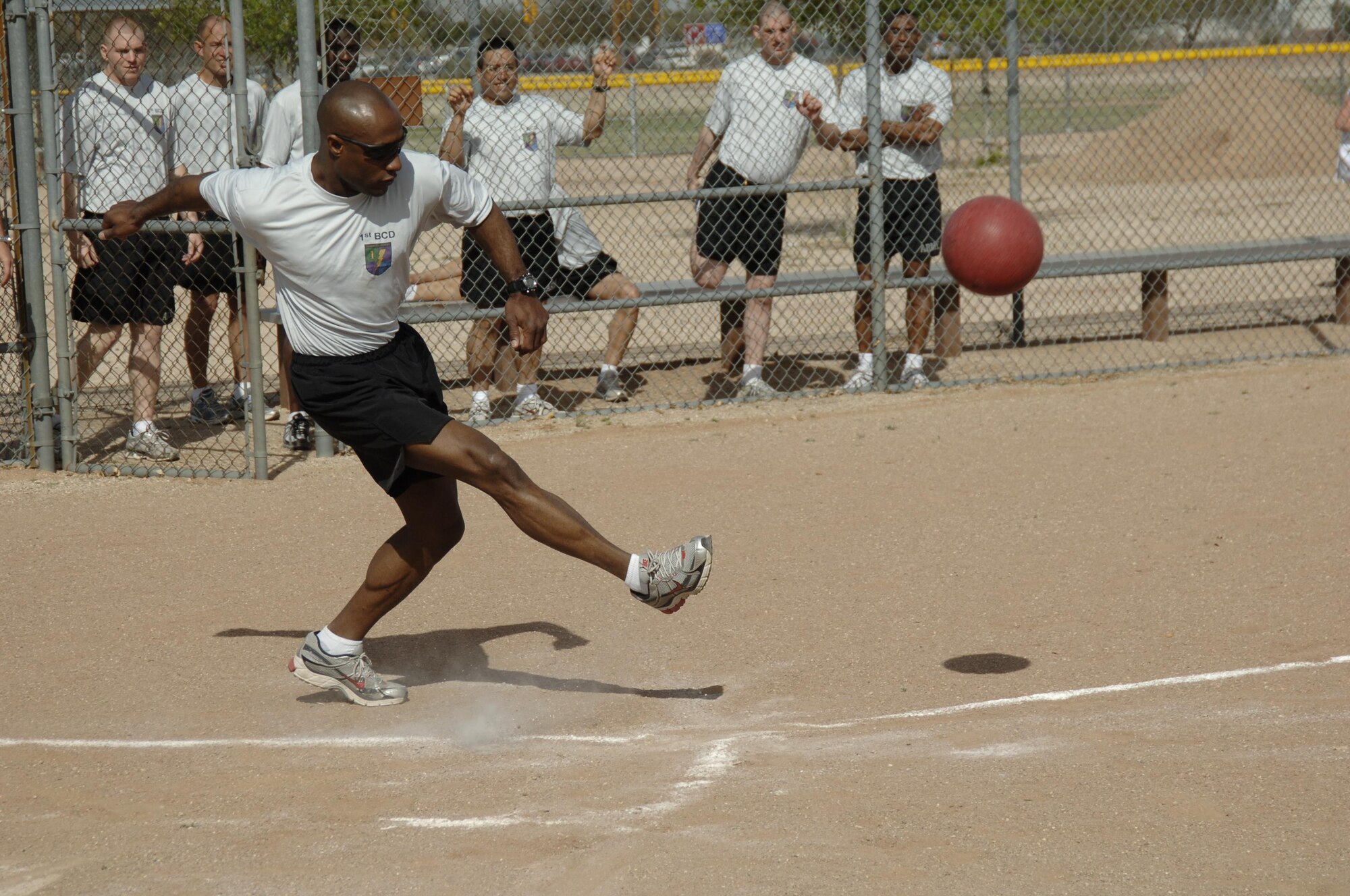 DAVIS-MONTHAN AIR FORCE BASE, Ariz. -- Sergeant Shawn Swindall, 1st Battlefield Coordination Detachment, sends the ball flying during the kickball competition of the 12th Air Force (Air Forces Southern) sports day March 20.  This is the first time 1st BCD has had enough manpower to field a full team, and they won first place at the end of the day. More than 200 members of 12th AF competed in the event. (U.S. Air Force photo by Tech. Sgt. Eric Petosky) 
