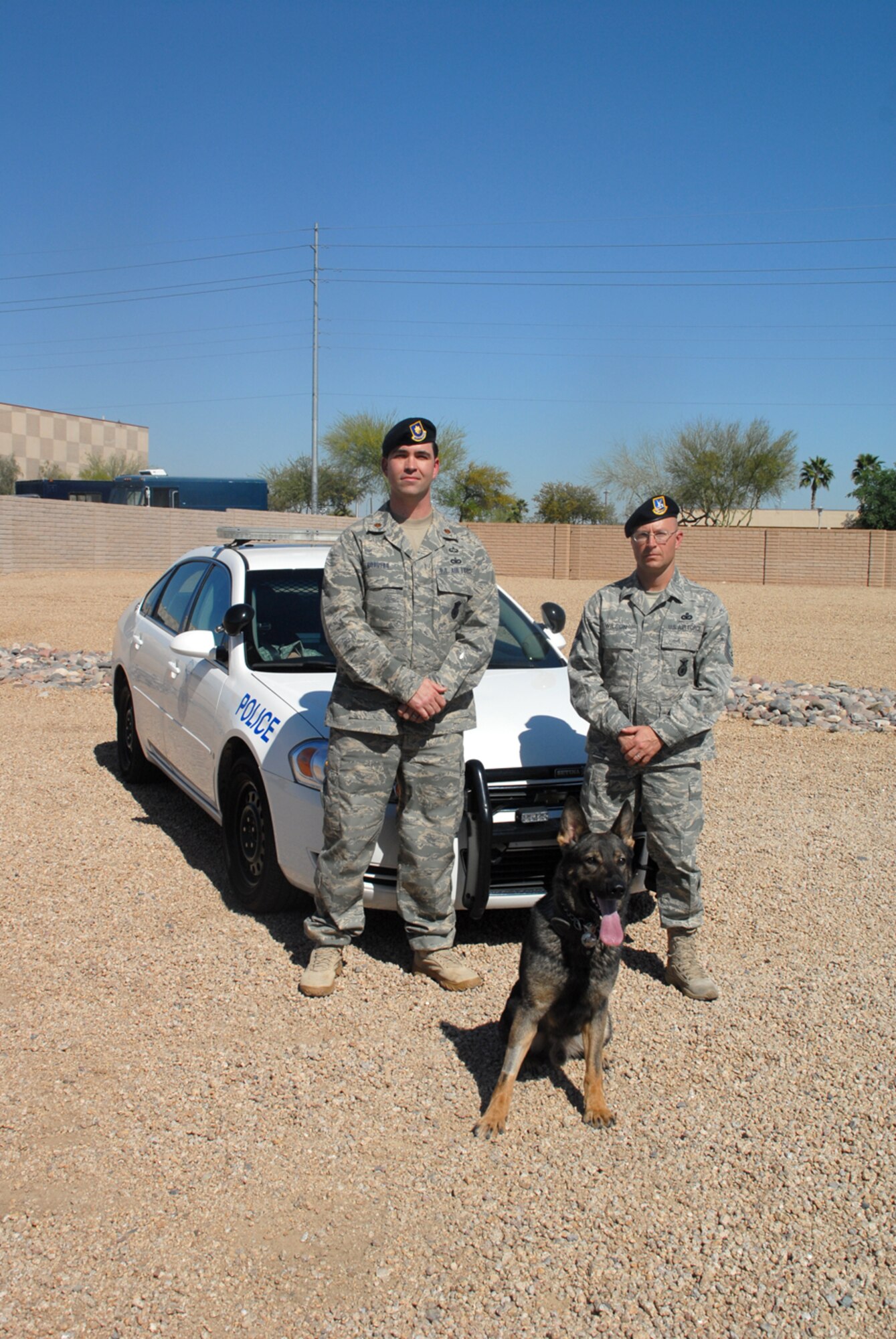 Maj. Michael Borders Jr., 56th SFS commander and Chief Master Sgt. Patrick Wilson, 56th SFS superintendent poses with military working dog Oscar, after the unit captured the Air Force Outstanding Security Forces (medium) Unit award for 2008. The unit also received 67 other awards and accolades. 

