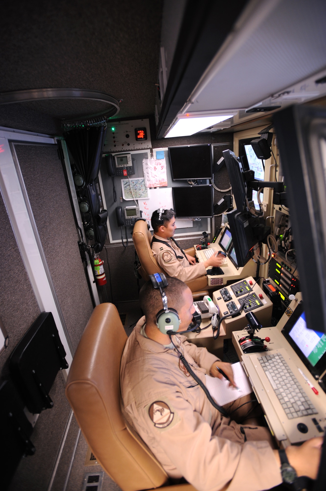 Capt. Ryan Jodoi (rear) flies an MQ-9 Reaper while Airman 1st Class Patrick Snyder controls a full motion video camera March 13 at Kandahar Air Base, Afghanistan. (U.S. Air Force photo/Staff Sgt. James L. Harper Jr.)