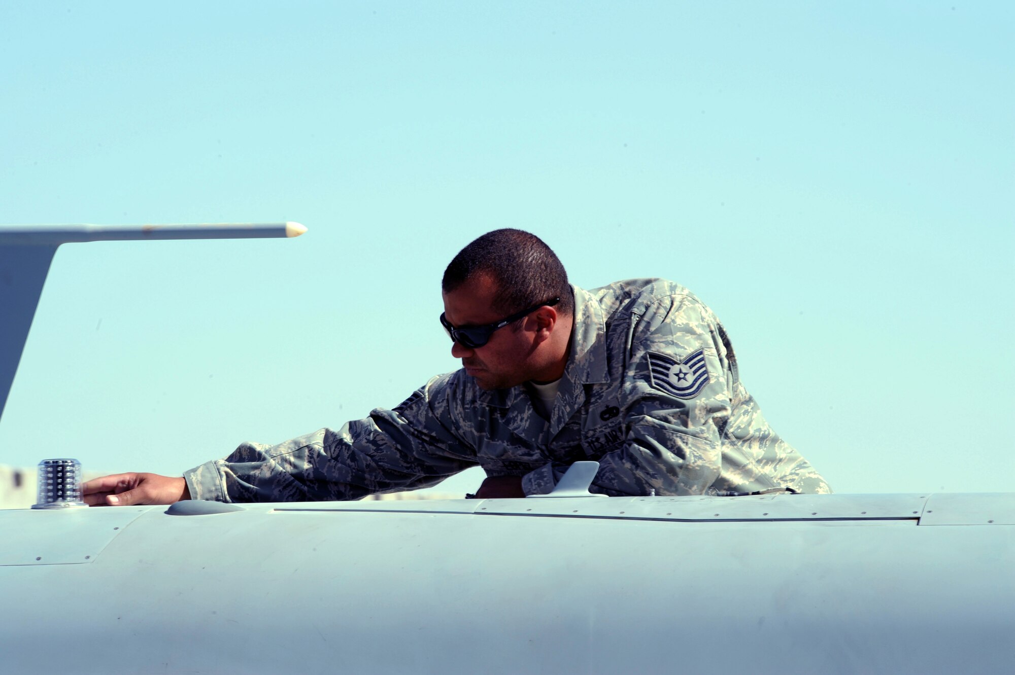 Tech. Sgt. Ismael Lopez inspects an MQ-9 Reaper for cracks and other damage March 13 at Kandahar Air Base, Afghanistan.  Sergeant Lopez is a quality assurance technician with the 62nd Expeditionary Reconnaissance Squadron. (U.S. Air Force photo/Staff Sgt. James L. Harper Jr.)