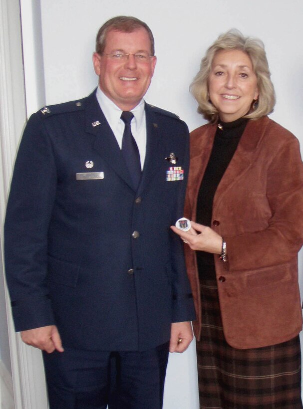Col. David Culbertson, 926th Group commander, presents Rep. Dina Titus with her first military coin during a recent visit to Capitol Hill. By tradition, a coin bears the organization's insignia and serves to prove membership. The 926th GP is a U.S. Air Force Reserve unit fully integrated into the United States Air Force Warfare Center at Nellis Air Force Base, Nev. Reserve personnel work alongside regular Air Force personnel on a daily basis to accomplish the mission. (courtesy photo)