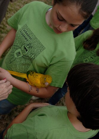 Charleston area elementary school students hold a bird during the Earth Day celebration on Charleston AFB, March 25. More than 600 students came to the base's 13th Earth Day celebration. (U.S. Air Force photo/Senior Airman Katie Gieratz)