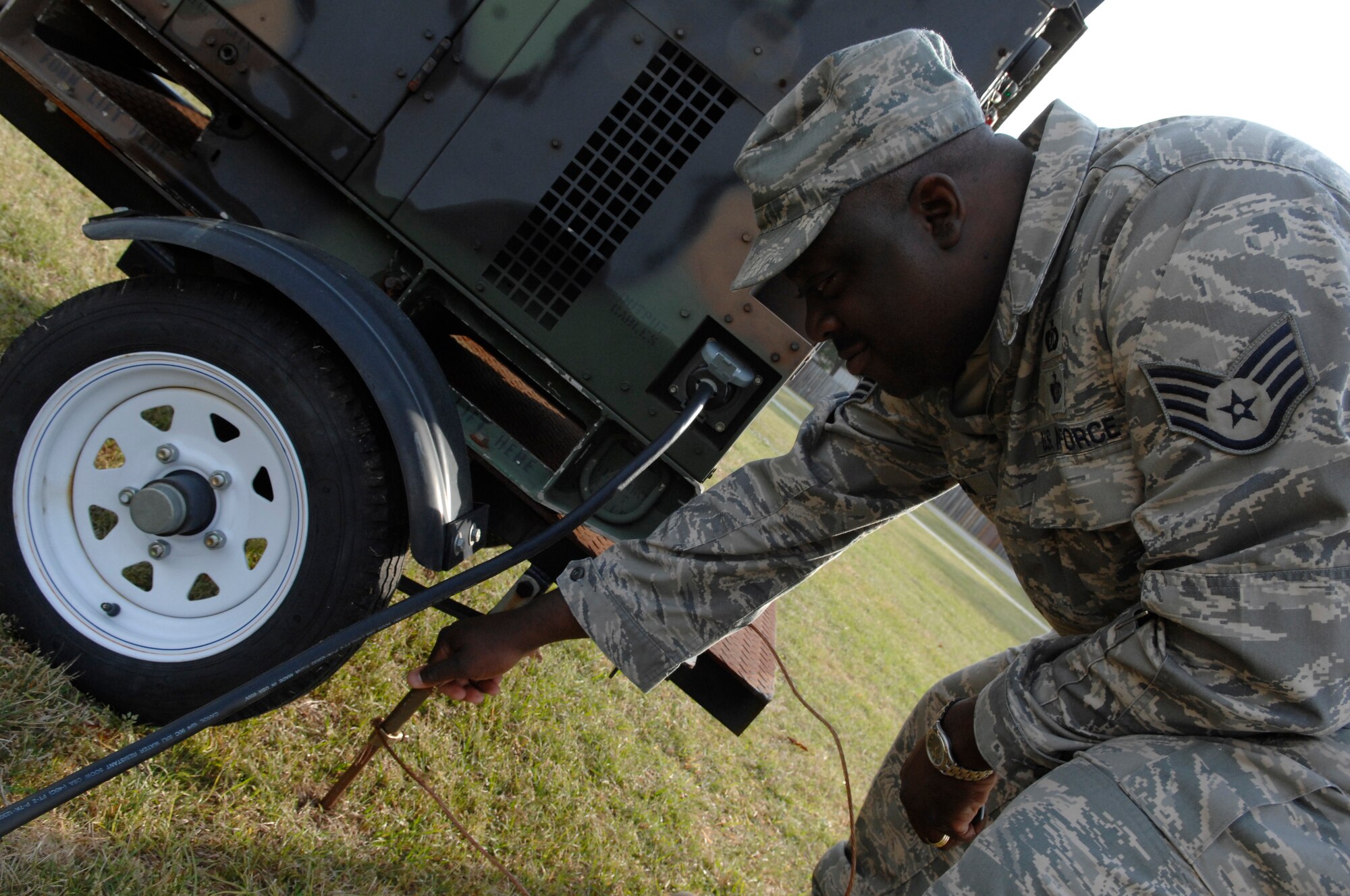 Staff Sgt. Jeffrey Graham makes sure a grounding wire is secure during a safety inspection at the picnic grounds for Earth Day on Charleston AFB, March 25.  The safety office oversees the wing commander's Mishap Prevention Program through basewide inspections, education and investigations.  Sergeant Graham is a confined space manager with the 437th Airlift Wing Ground Safety office. (U.S. Air Force photo/Senior Airman Katie Gieratz)