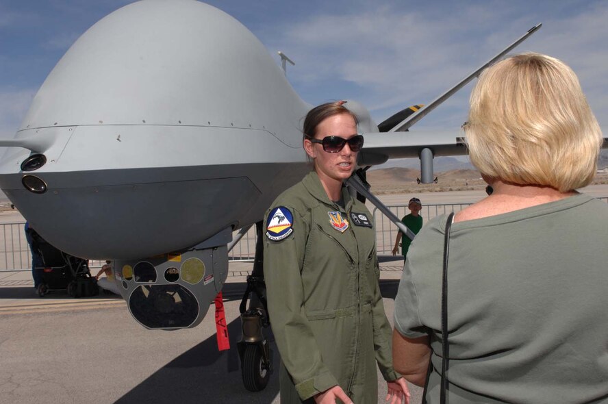 CREECH AFB, Nev. -- Airman 1st Class Amanda Holland, a sensor operator assigned to the 42nd Attack Squadron, explains the specifications of a MQ-9 Reaper to a guest during the Indian Springs Appreciation day at Creech AFB, Nev., Mar. 17, 2009. (U.S. Air Force photo/Senior Airman Larry E. Reid Jr.) 