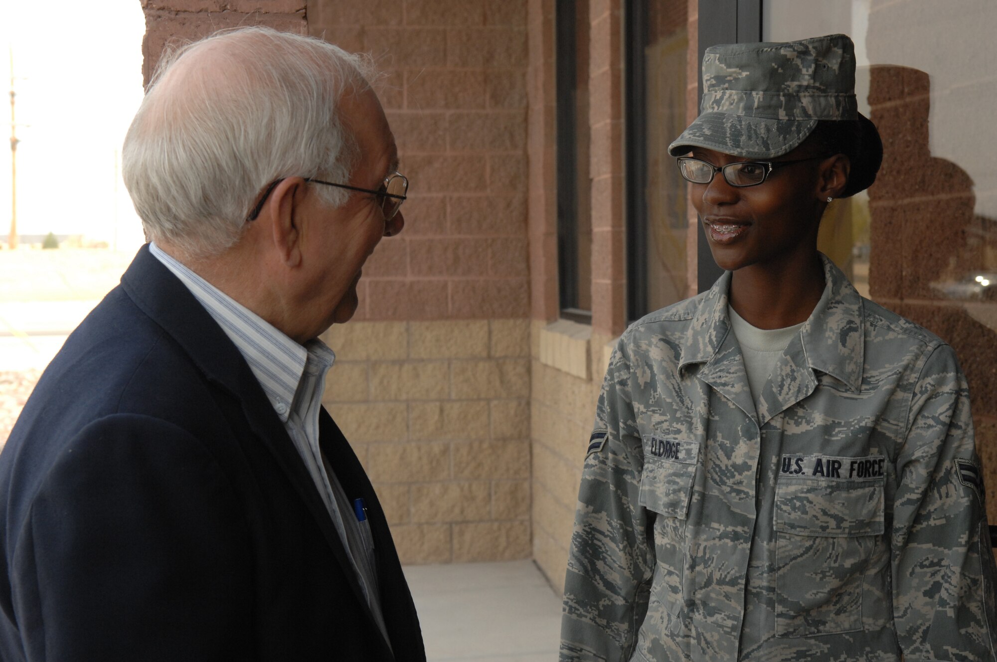Airman 1st Class Trenise Eldrigde welcomes the 8th Chief Master Sgt. of the Air Force, Chief Master Sgt. Sam Parish (ret.) to the Honor Guard building March 20 at Holloman Air Force Base, N.M. Airman Eldrigde is an Information Manager assigned to the 49th Fighter Wing. (U.S. Air Force photo/SSgt Anthony Nelson Jr)