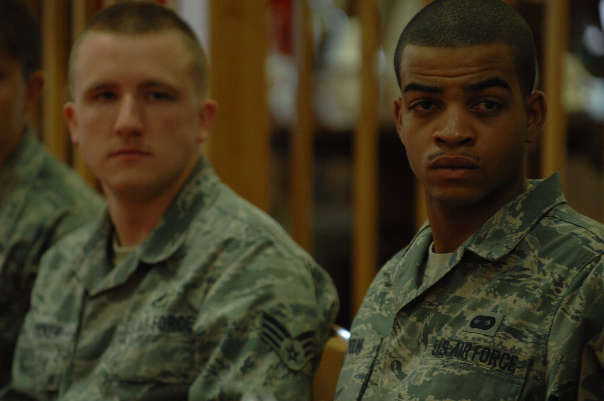 Senior Airman Thomas Young listens as the 8th Chief Master Sgt. of the Air Force, Chief Master Sgt. Sam Parish (ret.) talks to Airmen during breakfast at the Shifting Sands Dining Facility at Holloman Air Force Base, N.M. March 20. Airman Young is an Information Manager assigned to the 49th Material Maintenance Group at Holloman. (U.S. Air Force photo/SSgt Anthony Nelson Jr)