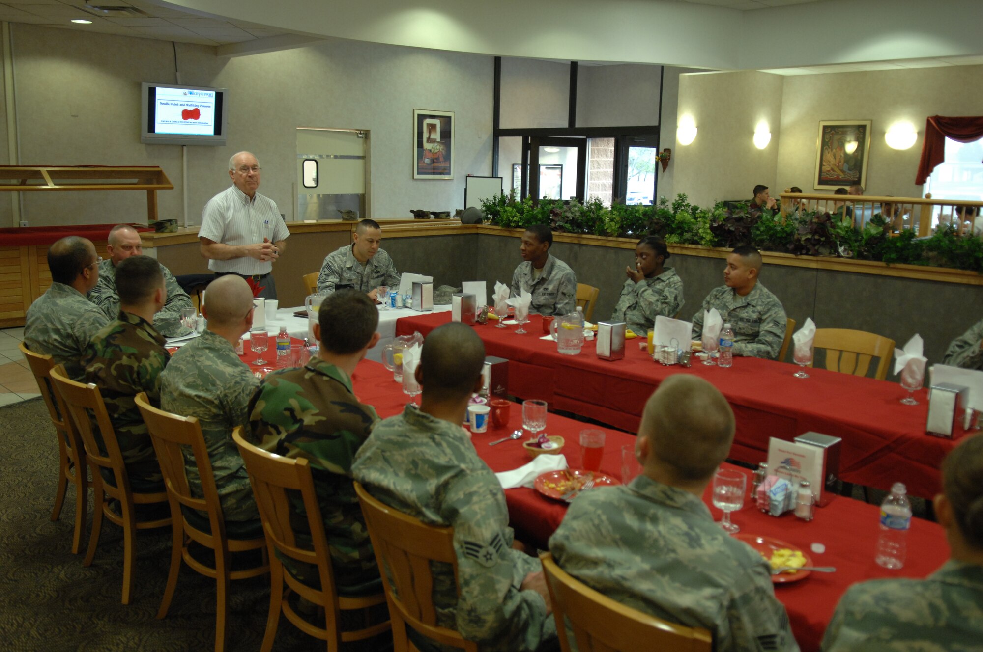 The 8th Chief Master Sgt. of the Air Force, Chief Master Sgt. Sam Parish (ret.), talks to Airmen during breakfast at the Shifting Sands Dining Facility at Holloman Air Force Base, N.M., March 20. The retired chief also recognized Holloman's newest Chief Master Sergeants during his visit. (U.S. Air Force photo/SSgt Anthony Nelson Jr)