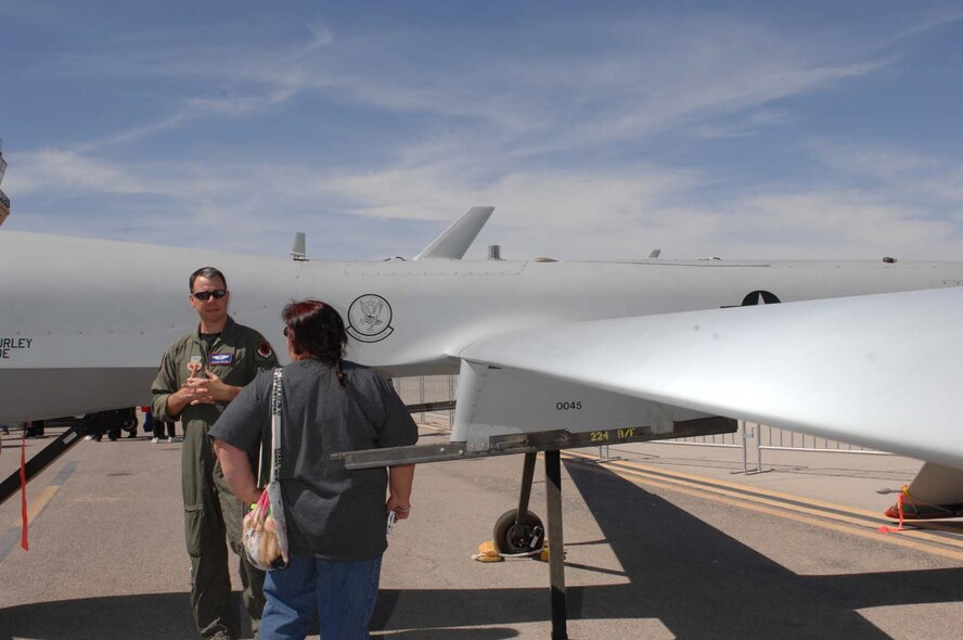 CREECH AFB, Nev. -- Major Michael Branch, a pilot assigned to the 11th Reconnaissance Squadron pilot, explains the specifications of a MQ-1B Predator to a guest during the Indian Springs Appreciation day at Creech AFB, Nev., Mar. 17, 2009. (U.S. Air Force Photo/Senior Airman Larry E. Reid Jr.)