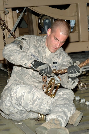 Airman 1st Class David Marcum secures a Mine-Resistant, Ambush-Protected egress simulator onto a C-5 here March 20. The simulators are used to train deployed military members how to egress out of a MRAP that has overturned. Airman Marcum is with the 437th Aerial Port Squadron. (U.S. Air Force photo/Staff Sgt. Marie Cassetty)(RELEASED)