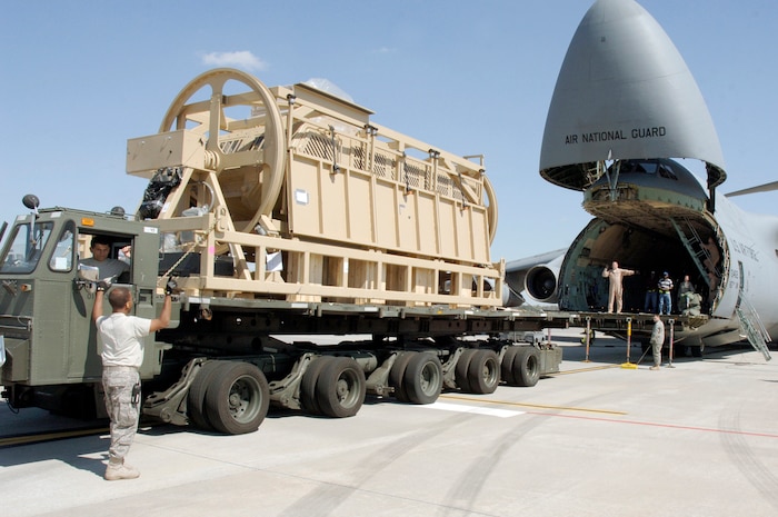 Senior Airman Raymond Banks guides a 60k loader into position to load a Mine-Resistant, Ambush-Protected egress simulator here March 20. The simulators are used to train deployed military members how to egress out of a MRAP that has overturned. Airman Banks is with the 437th Aerial Port Squadron. (U.S. Air Force photo/Staff Sgt. Marie Cassetty)(RELEASED)
