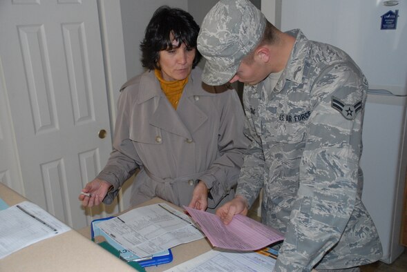 (Left) Mitzi McGowan, 436th Arial Port Squadron quality assurance inspector, goes over an inventory sheet with Airman First Class Tyler Craig, 436th Logistics Readiness Squadron.  Ms. McGowan advises servicemembers in-processing or out-processing on how to fill out inventory sheets to ensure all items are accounted for and any damages are annotated correctly on the form.  (U.S. Air Force photo/Staff Sgt. Chad Padgett)