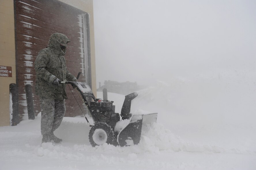 MINOT AIR FORCE BASE, N.D. – Airman 1st Class Aaron Gardner, a readiness apprentice from the 5th Civil Engineer Squadron operates a snow blower during a blizzard here March 24. Airmen from the 5th Bomb Wing and 91st Missile Wing were released early due to the forecasted hazardous weather conditions. (U.S. Air Force photo by Senior Airman Kelly Timney)