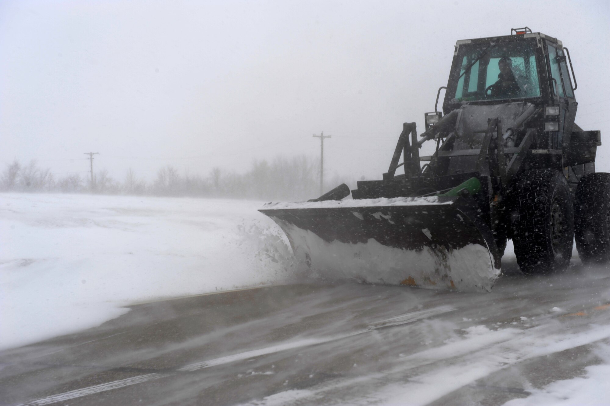 MINOT AIR FORCE BASE, N.D. – Snow plows are hard at work trying to keep up with the snow removal here during a blizzard March 24. Airmen from the 5th Bomb Wing and 91st Missile Wing were released early due to the forecasted hazardous weather conditions. (U.S. Air Force photo by Senior Airman Kelly Timney)