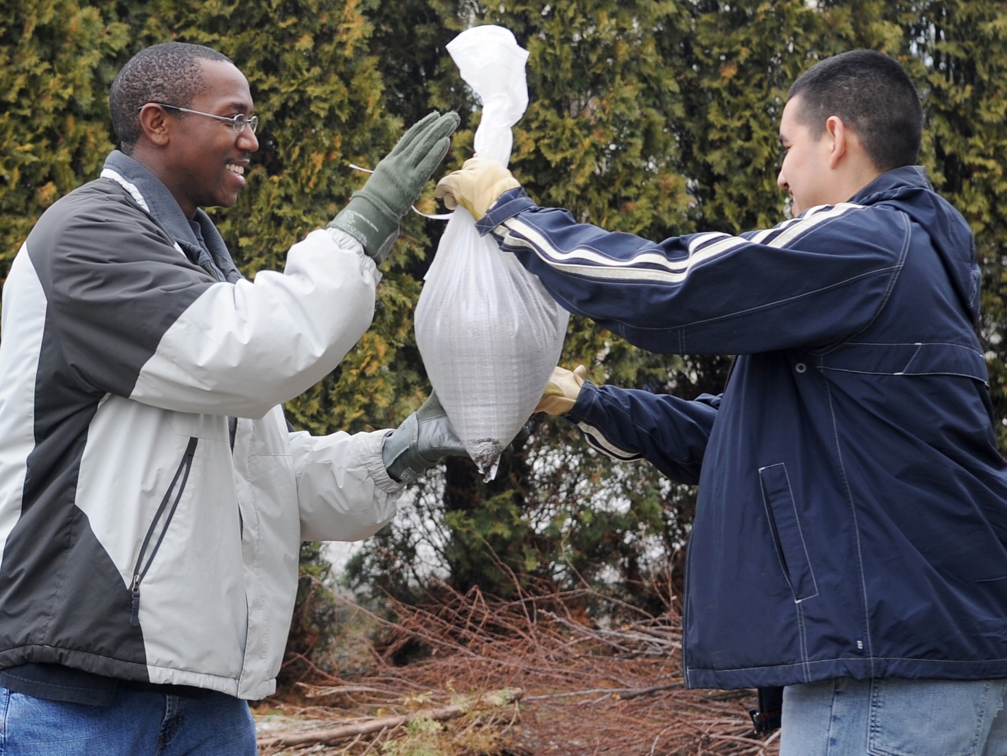 Staff Sgt. Nathaniel Newkirk (left) and Senior Airman Isaac Zavala are part of a human sandbag chain comprised of neighbors and volunteers in Fargo, N.D. The Airmen are supporting the flood preparation efforts by volunteering at many locations throughout the Red River Valley. Sergeant Newkirk and Airman Zavala are both from the 319th Operations Support Squadron at Grand Forks Air Force Base, N.C. (U.S. Air Force photo/Tech. Sgt. Amanda Callahan)