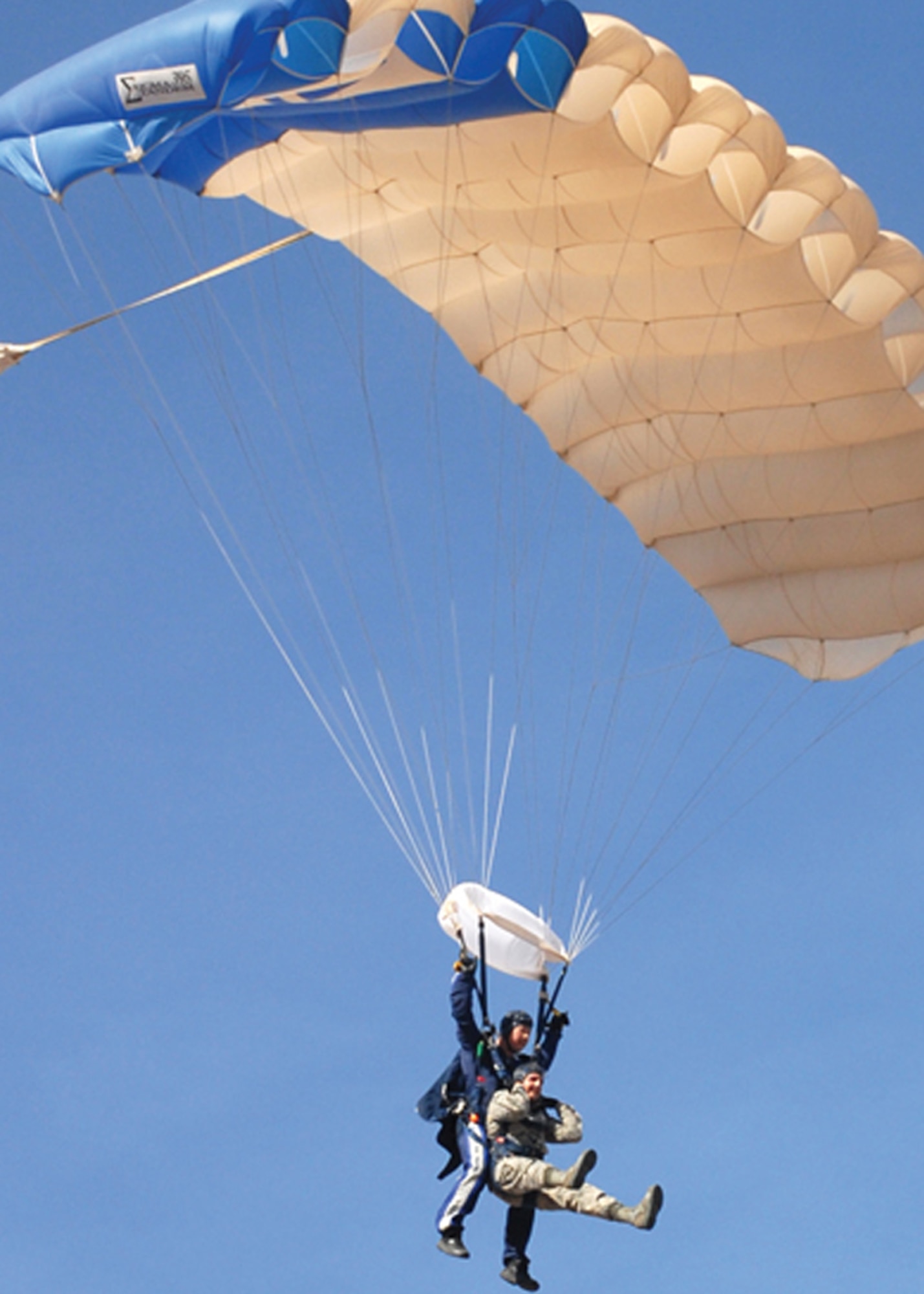 Senior Airman Gary Nelson, 56th Maintenance Group, and Master Sgt. Richard McClure, 98th Flying Training Squadron jump staff, prepare to land at the Gila Bend Air Force Auxiliary Field during a tandem jump March 19.(U.S. Air Force photo/ Airman 1st Class Tracie Forte)
