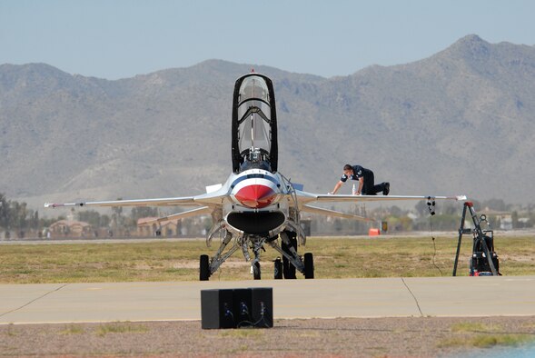 A U.S. Air Force Thunderbirds Aerial Demonstration Team maintenance crew member prepares one of the Thunderbird F-16 Fighting Falcons for the 2009 Thunder in the Desert Open House and Air Show March 21. The Thunderbirds performance at Luke kicked off their 2009 season in which they will be flying at more than 70 shows across the United States. (photo/Deborah Silliman Wolfe)