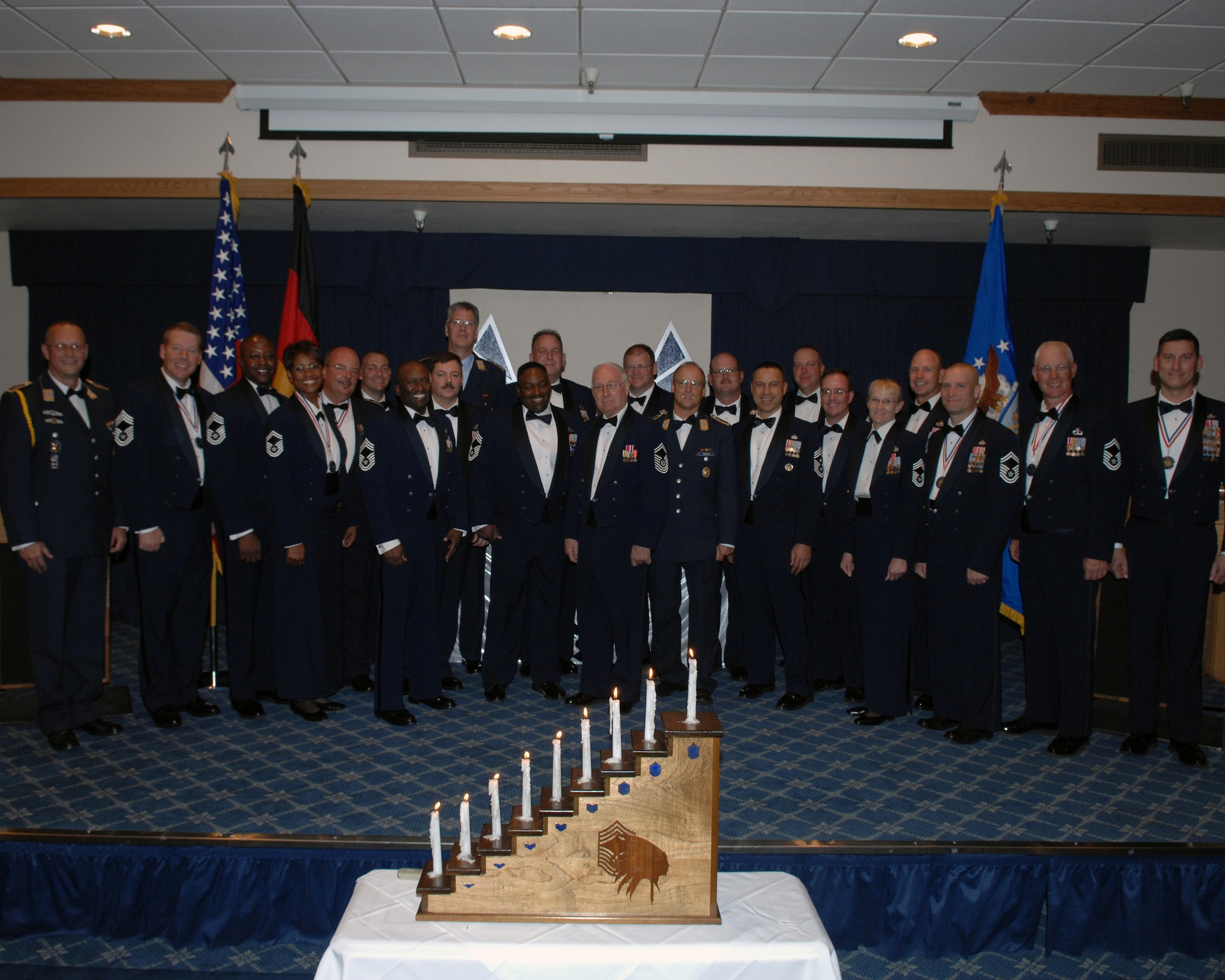 The newest Chief Master Sergeants assigned to Holloman Air Force Base, N.M., takes a group photo with the 8th Chief Master Sgt. of the Air Force, Retired Chief Master Sgt. Sam Parish during the Chief Recognition Ceremony  March 21 at Holloman Air Force Base, N.M. (U.S. Air Force photo/SSgt Anthony Nelson Jr)