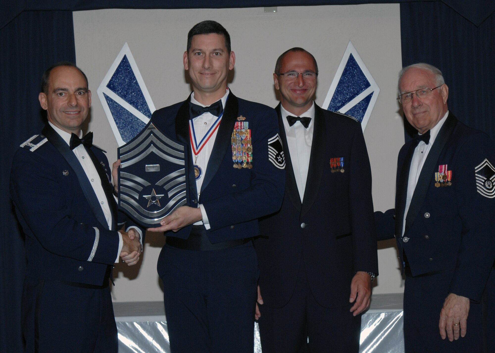 49th Fighter Wing Commander Col. Jeff Harrigian and German Flying Training Center Vice Commander Col. Hans Jocahim Weber along with the 8th Chief Master Sgt. of the Air Force, Chief Master Sgt. Sam Parish (ret.) recognizes Chief Master Sgt. Billy Davis as one of the Air Force's newest Chief Master Sergeants during the Chief Recognition Ceremony March 21 at Holloman Air Force Base, N.M. (U.S. Air Force photo/SSgt Anthony Nelson Jr)