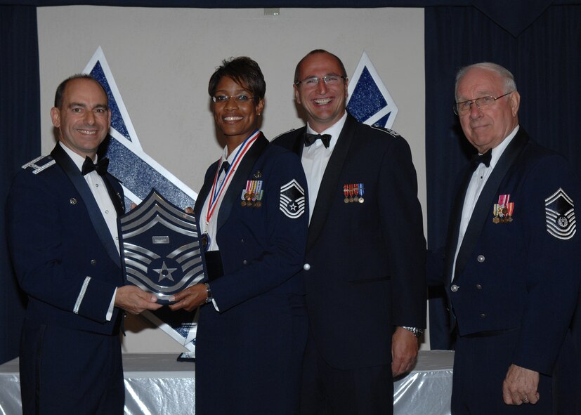 49th Fighter Wing Commander Col. Jeff Harrigian and German Flying Training Center Vice Commander Col. Hans Jocahim Weber along with the 8th Chief Master Sgt. of the Air Force, Chief Master Sgt. Sam Parish (ret.), recognizes Chief Master Sgt. Kim Baker as one of the Air Force's newest Chief Master Sergeants during the Chief Recognition Ceremony March 21 at Holloman Air Force Base, N.M. (U.S. Air Force photo/SSgt Anthony Nelson Jr)