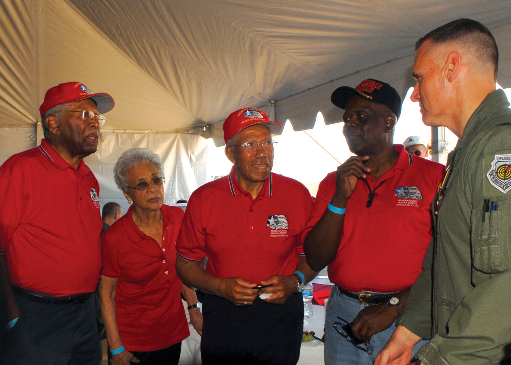 Lt. Col. Asa Herring, former Tuskegee Airman, Mrs. Honor Herring, Dr. Thurston Gains, former Tuskegee Airman, and Mr. Al Atuculle, a member of the local chapter of Tuskegee Airmen, talk with Brig. Gen. Kurt Neubauer, 56th Fighter Wing commander, in the VIP tent during Luke Days 2009 Thunder in the Desert Open House and Air Show Saturday. (U.S. Air Force photo/Airman 1st Class Ronifel Yasay)