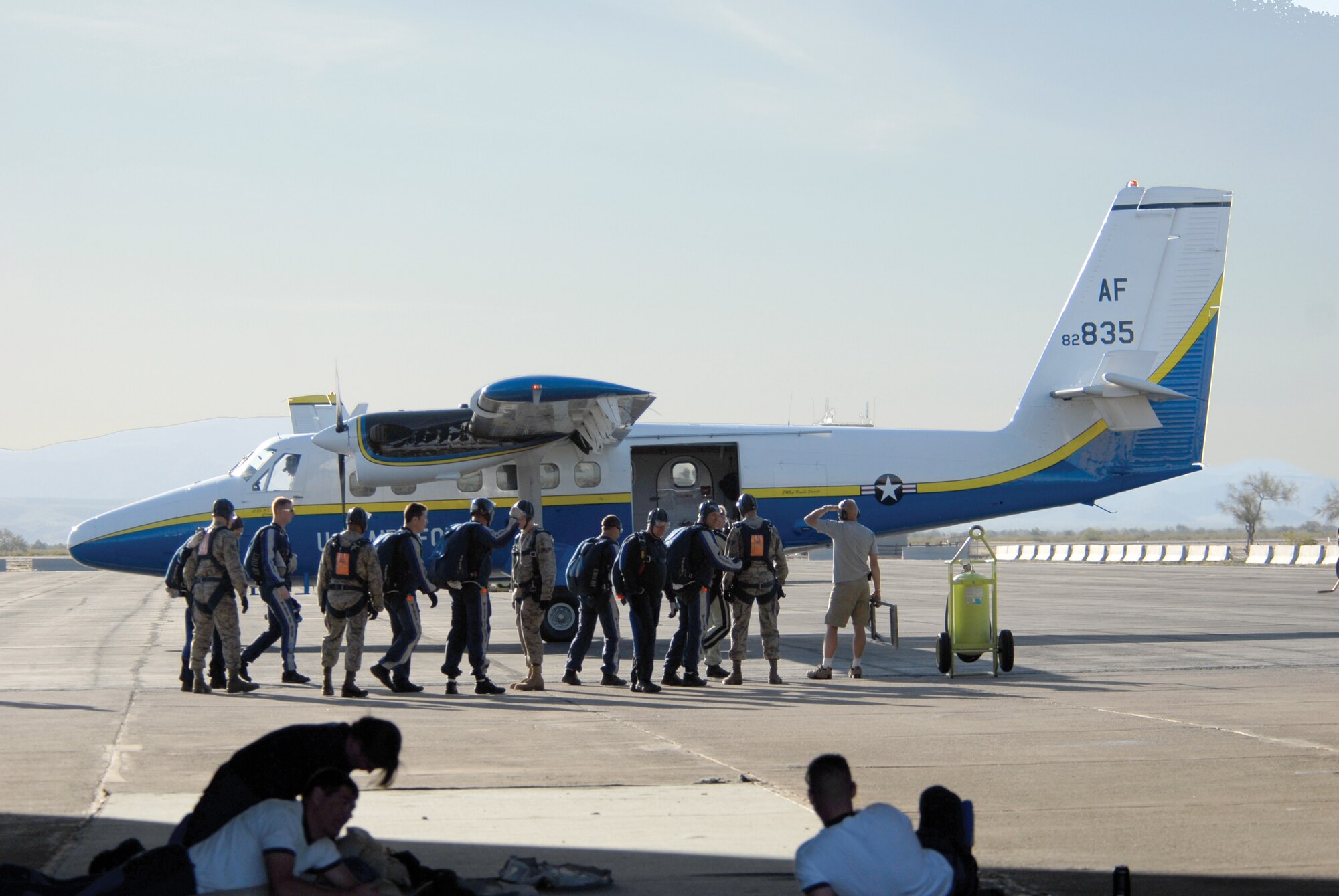 Four Luke Airmen and members of the U.S. Air Force Academy Wings of Blue Parachute Team prepare to board a UV-18 aircraft March 19 at Gila Bend Auxiliary Field. The Luke members tandem jumped with members of the team reaching speeds of 120 miles-per-hour. (photo/Deborah Silliman Wolfe)