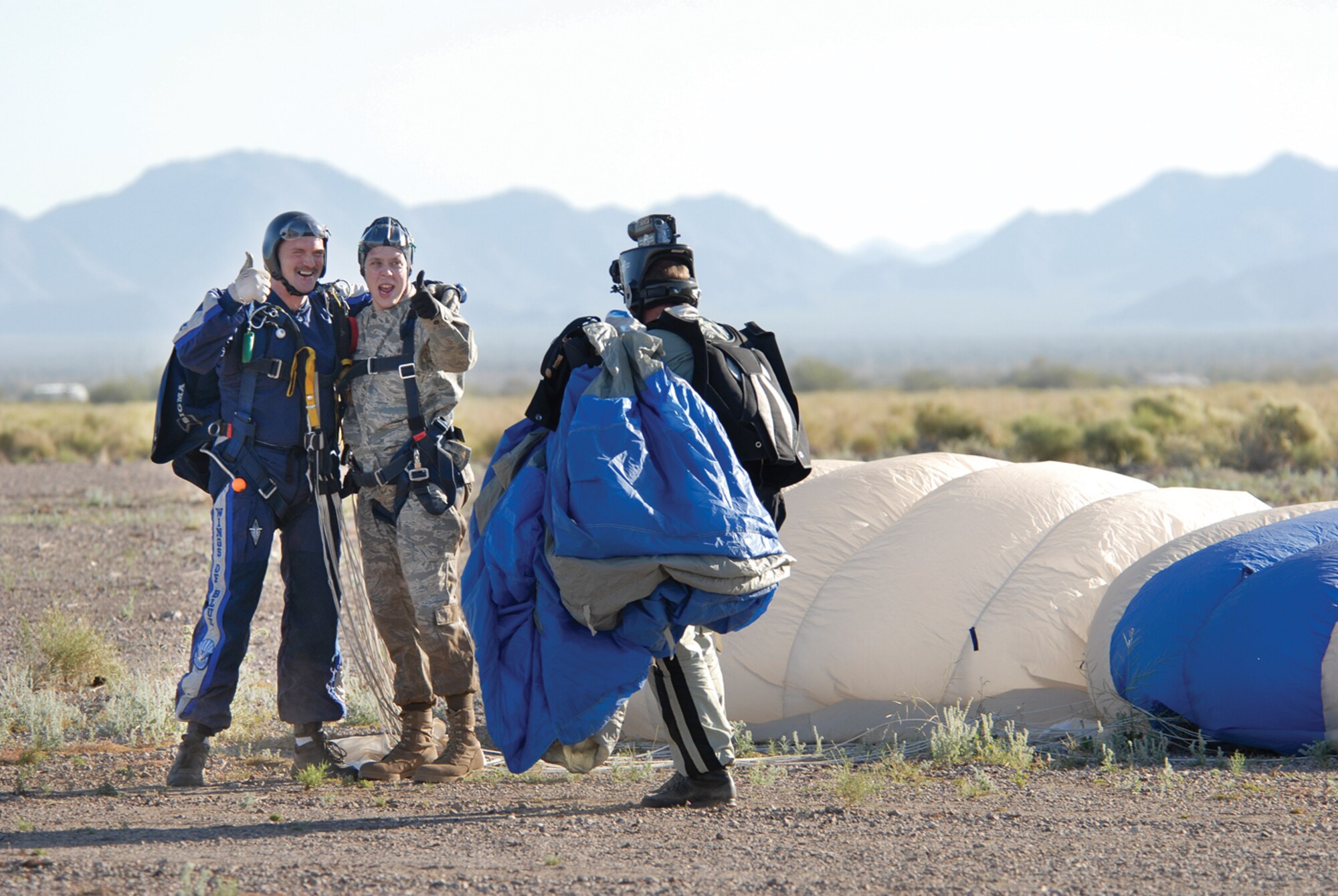 Senior Airman Bradley Snyder, 56th Medical Operations Squadron ambulance operations, and Lt. Col. Todd Aaron, 98th Flying Training Squadron U.S. Air Force Academy Wings of Blue Parachut Team pose for the final video shot of Airman Snyder’s tandem jump. (photo/Deborah Silliman Wolfe)