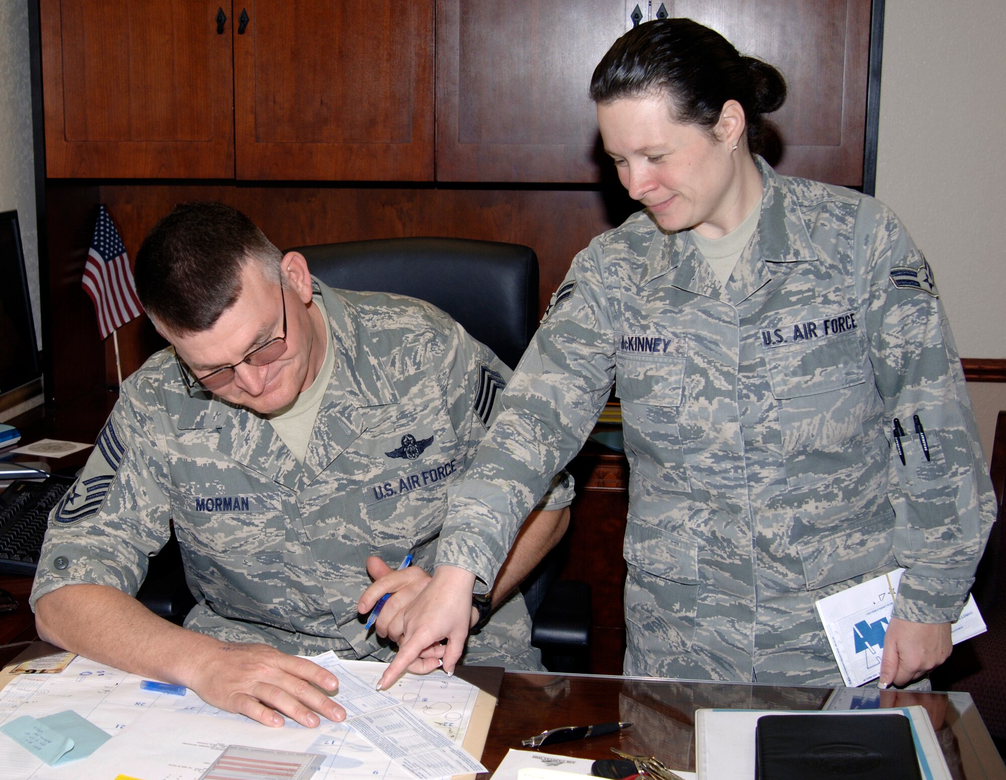 MCCONNELL AIR FORCE BASE, Kan. -- Airman 1st Class Tonya McKinney, 22nd Comptroller Squadron, assists Chief Master Sgt. James Morman, 22nd Air Refueling Wing interim command chief, with filling out the Air Force Assistance Fund form in his office, March 18. The Air Force form 2561 is available at www.afassistancefund.org.  Anyone can donate by cash, check or payroll deduction from their Air Force pay. (Photo by Senior Airman Laura Suttles)