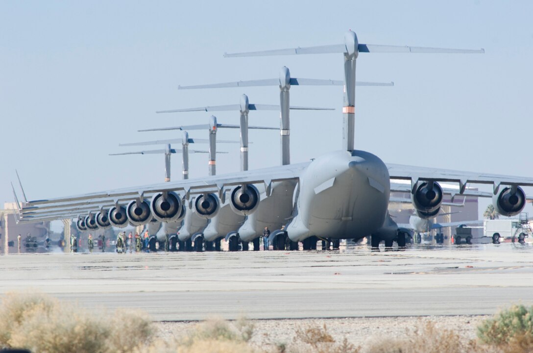 Six C-17 Globemaster IIIs park on Edwards flightline in preparation for a six-ship formation testing March 14 and 17. The C-17 is capable of rapid strategic delivery of troops and cargo to main operating bases or directly to forward bases in deployed environments. (U.S. Air Force photo/Mike Cassidy)