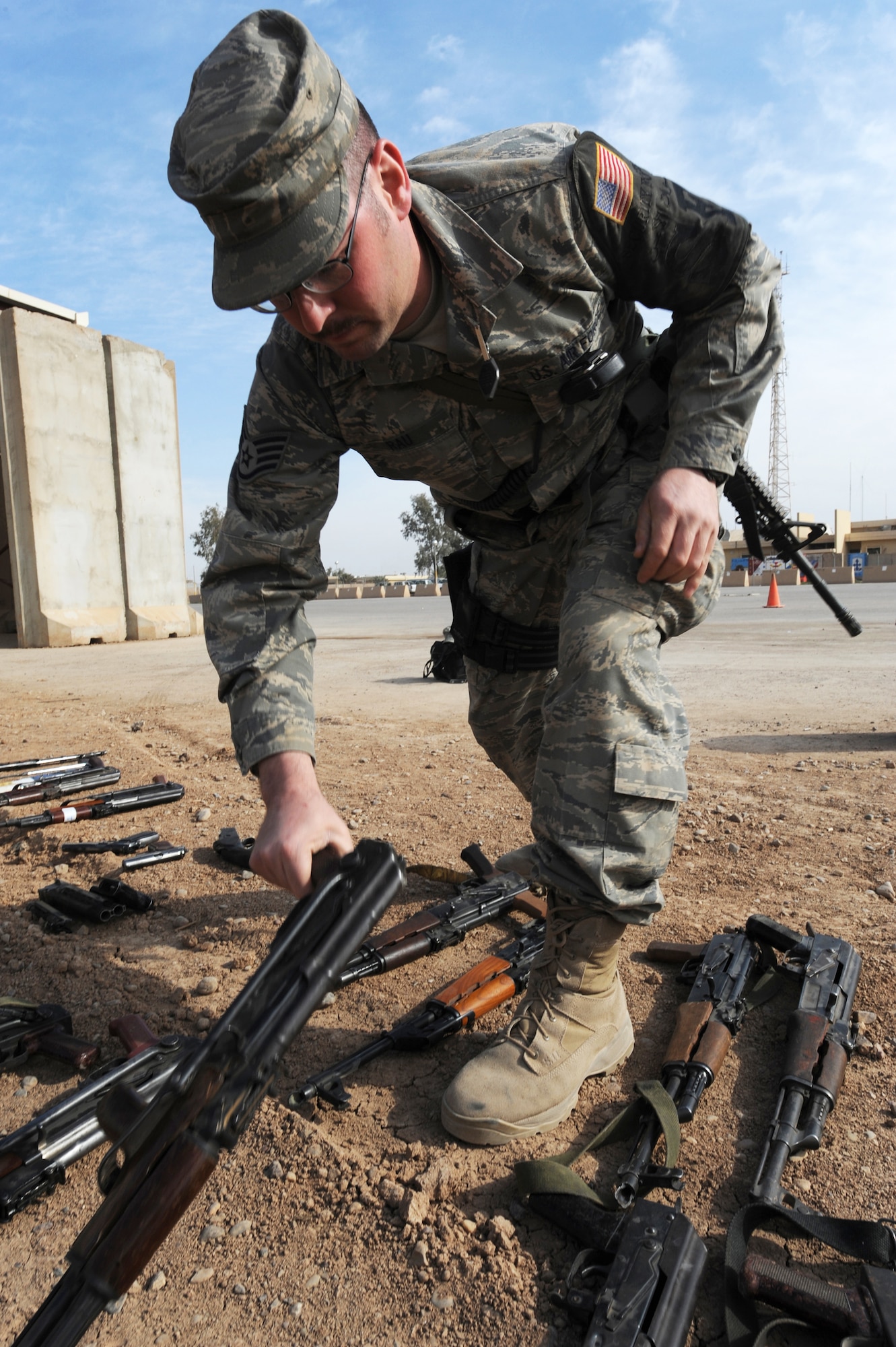 Staff Sgt. Richard Rau clears enemy weapons that have been laid out and marked for destruction at Joint Base Balad, Iraq, March 18. The various weapons were collected over time from amnesty boxes and units to enhance base security and force protection. Sergeant Rau is a 332nd Expeditionary Security Forces Squadron patrolman. (U.S. Air Force photo/Senior Airman Elizabeth Rissmiller)
