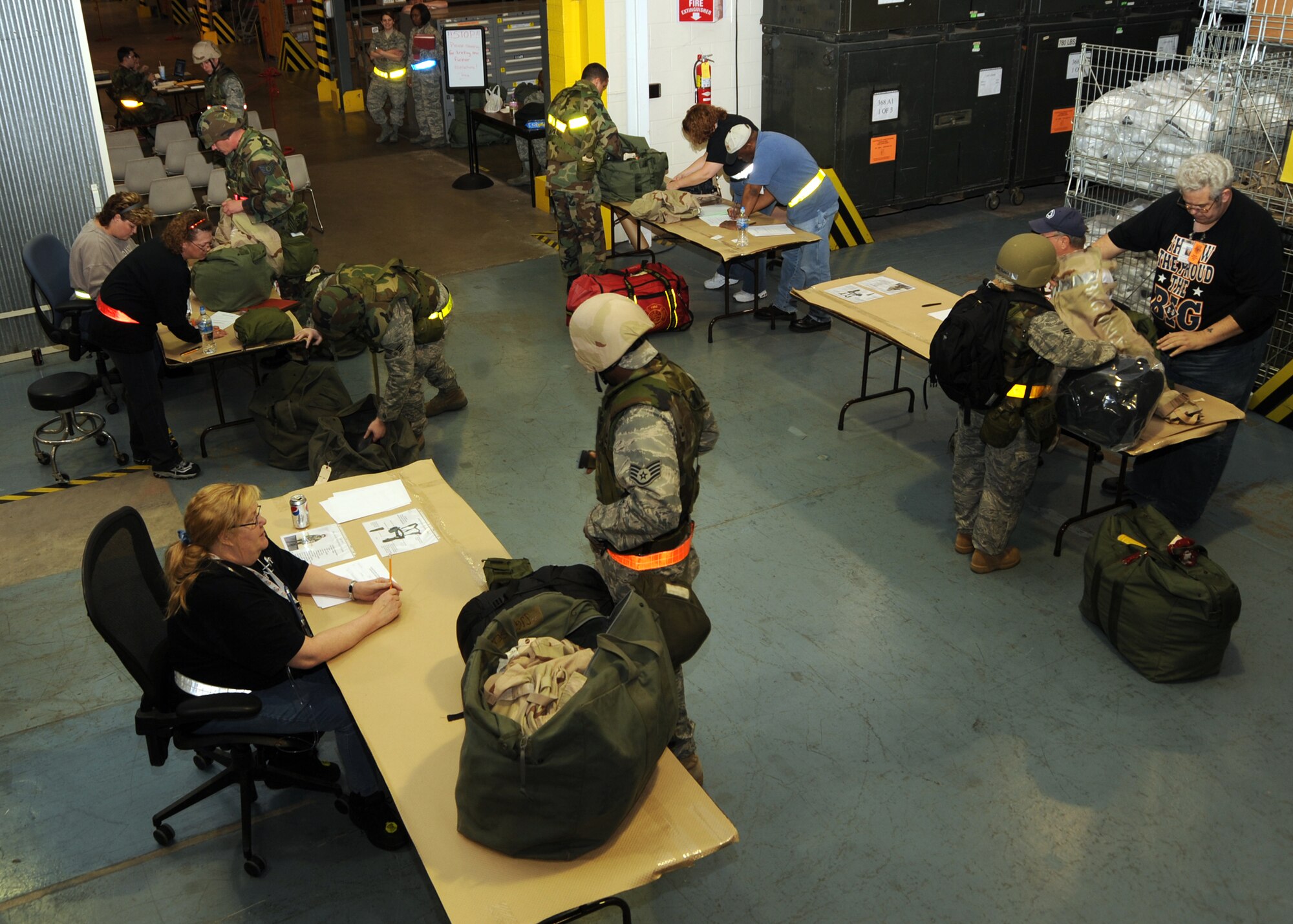 SCOTT AIR FORCE BASE, Ill. --Members of the War Readiness Element check to make sure 375th AW personnel have all the required chemical gear and proper placement of their field gear during the beginning of the mobility exercise. (U.S. Air Force photo/Airman 1st Class Wesley Farnsworth)