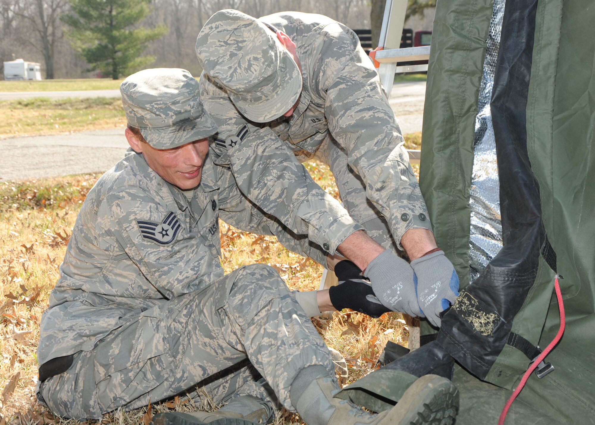 SCOTT AIR FORCE BASE, Ill. --Two members of the 375th Civil Engineer Squadron pull on the outside  fabric of a tent to affix it to the support poles.(U.S. Air Force photo/Tech. Sgt. Michelle Larche)