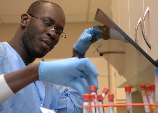 Senior Airman Alex Hastings places tubes in a machine that separates red blood cells from serum so that they are able to test the serum at the clinical laboratory on Charleston AFB, March 23. The lab receives more than 500 blood and urine samples weekly. Airman Hastings is a laboratory technician with the 437th Medical Group. (U.S. Air Force photo/Senior Airman Katie Gieratz)