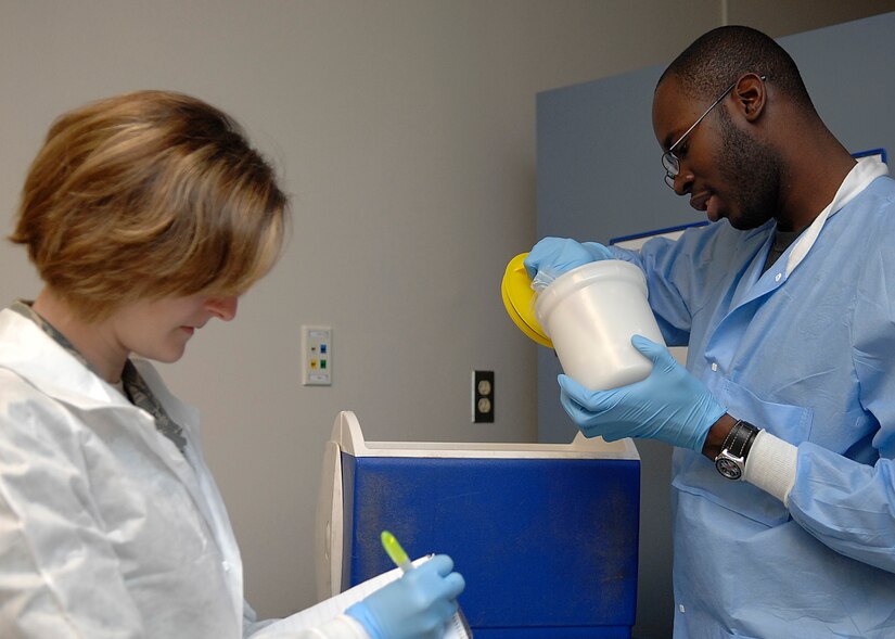 Senior Airman Alex Hastings trains Airman 1st Class Jessica Campbell on properly packing specimens for shipment to a specialized testing facility at the clinical laboratory on Charleston AFB, March 23. The lab receives more than  500 blood and urine samples weekly. Airman Hastings and Campbell are laboratory technicians with the 437th Medical Group. (U.S. Air Force photo/Senior Airman Katie Gieratz)