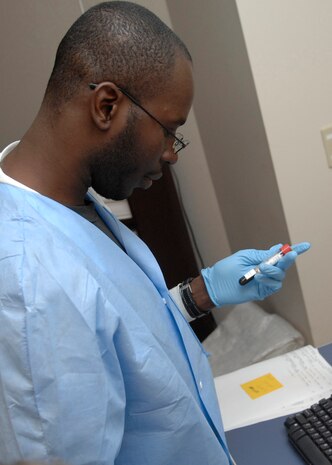 Senior Airman Alex Hastings logs patient samples into the computer at the clinical laboratory on Charleston AFB, March 23. The lab receives more than 500 blood and urine samples weekly. Airman Hastings is a laboratory technician with the 437th Medical Group. (U.S. Air Force photo/Senior Airman Katie Gieratz)