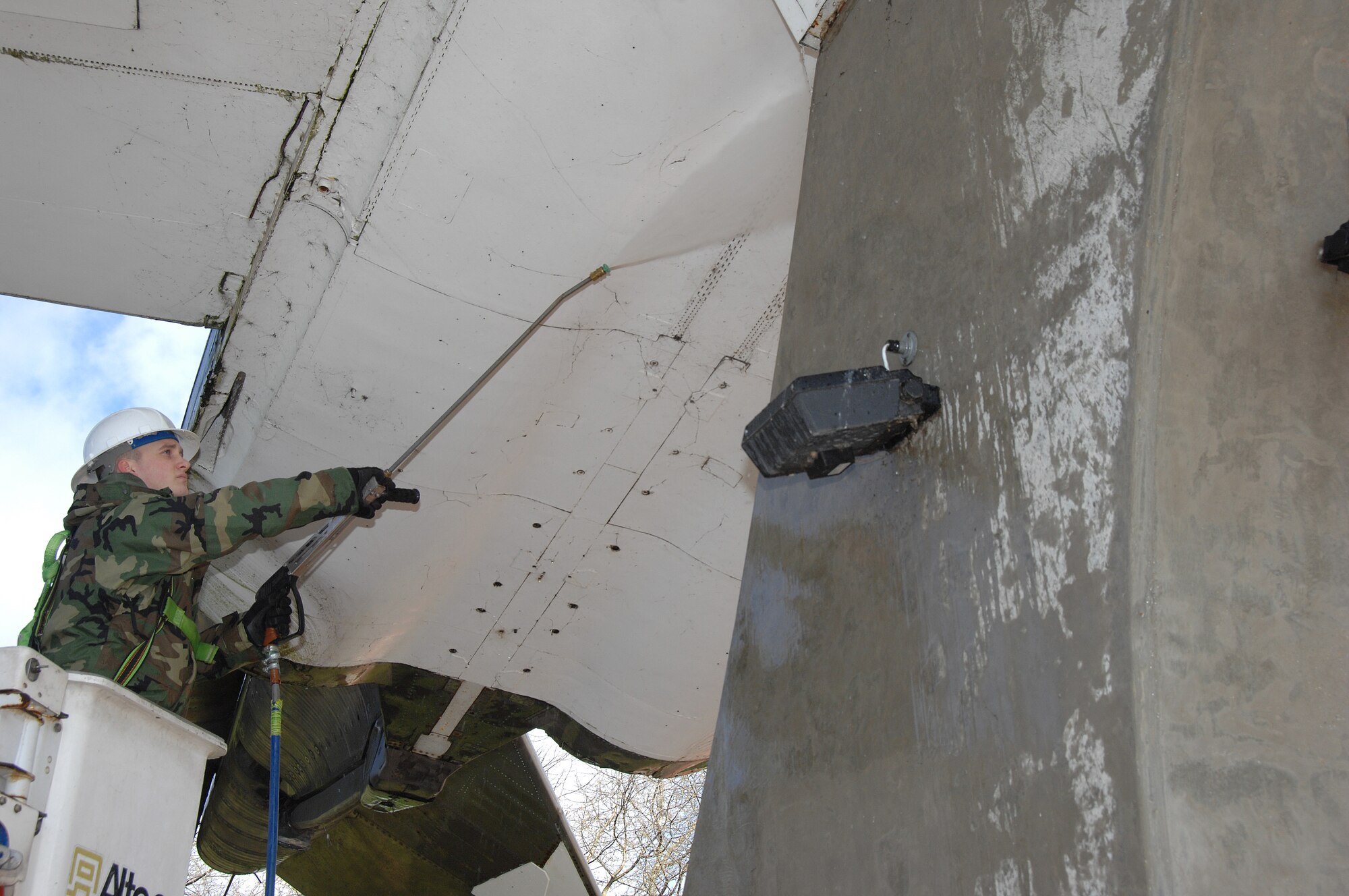 Senior Airman Jeremy Brown, 48th Fighter Wing Civil Engineer Squadron uses a pressure washer to clean debris off an aircraft at Memorial Park here March 25. The base took one day to perform a massive cleaning of the entire base and its facilities. (U.S. Air Force photo by Tech. Sgt. Christopher A. Campbell)