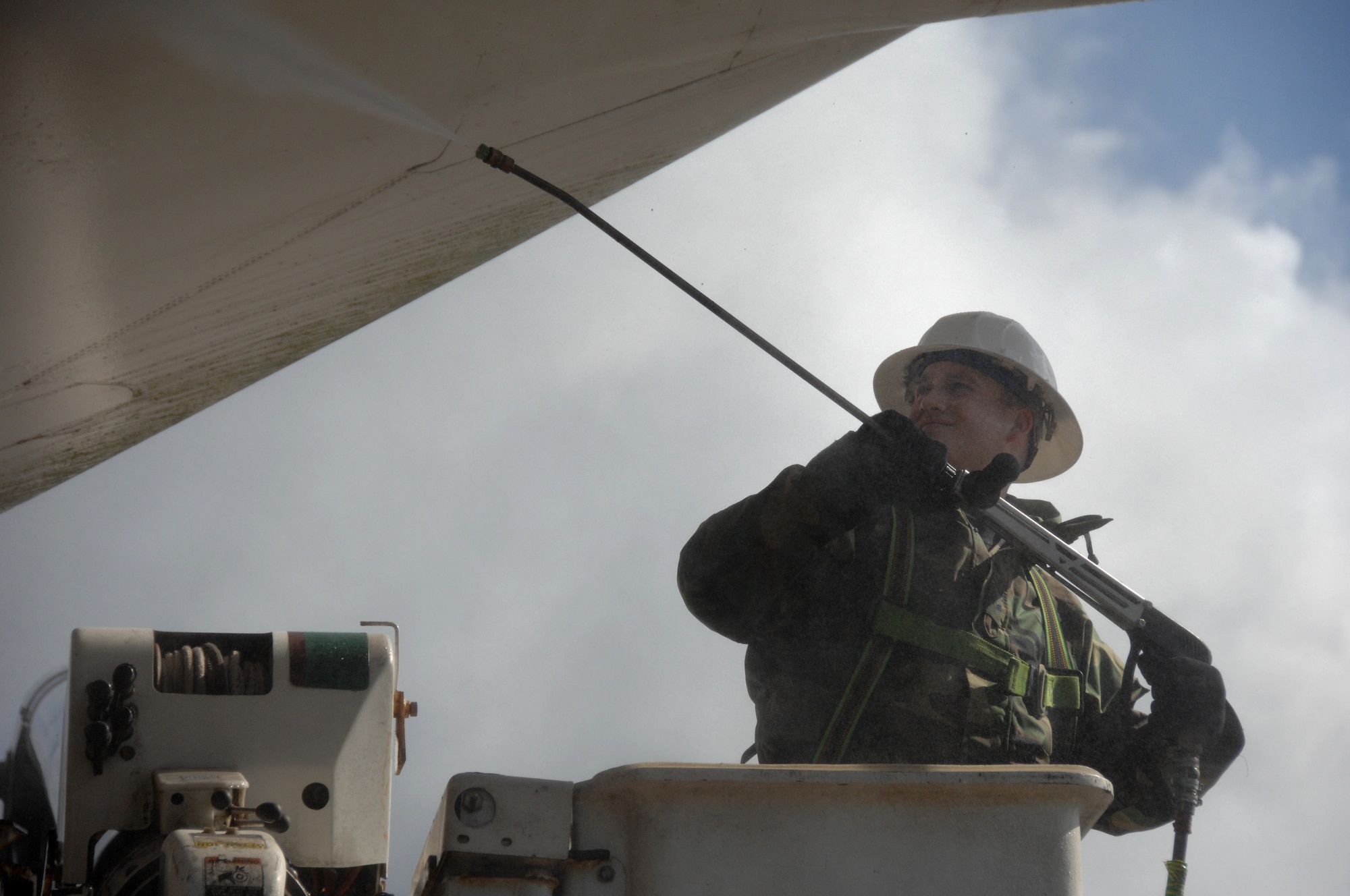 Senior Airman Jeremy Brown, 48th Fighter Wing Civil Engineer Squadron uses a pressure washer to clean debris off an aircraft at Memorial Park here March 25. The base took one day to perform a massive cleaning of the entire base and its facilities. (U.S. Air Force photo by Tech. Sgt. Christopher A. Campbell)