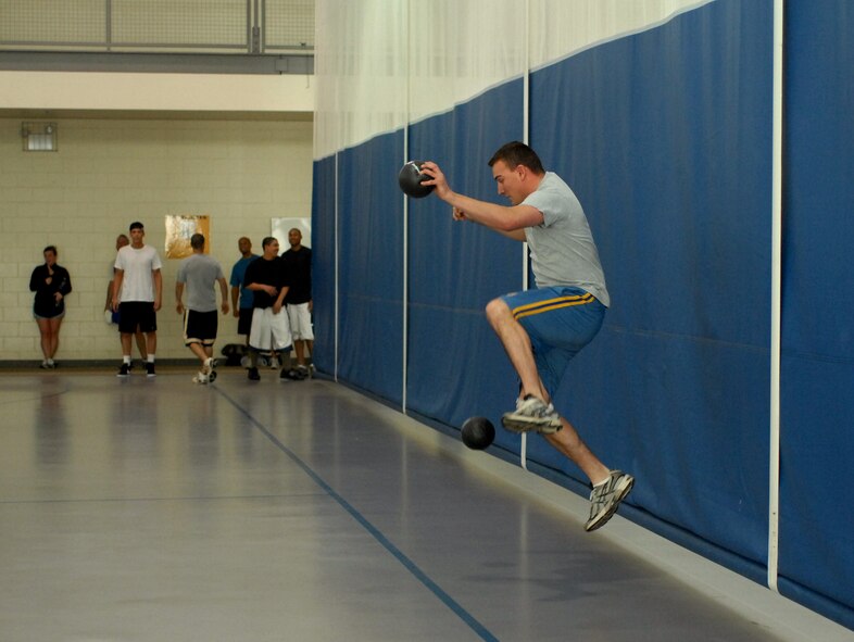 A servicemember jumps over a fast ball during the lunchtime dodgeball championship. (2d Lt. Amy Abbott/U.S. Air Force)