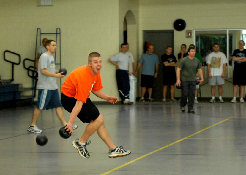Senior Airman John Rice, playing for the MUNZ Two team, dives and dodges in-coming fire during the dodgeball competition. (2d Lt. Amy M. Abbott/U.S. Air Force)