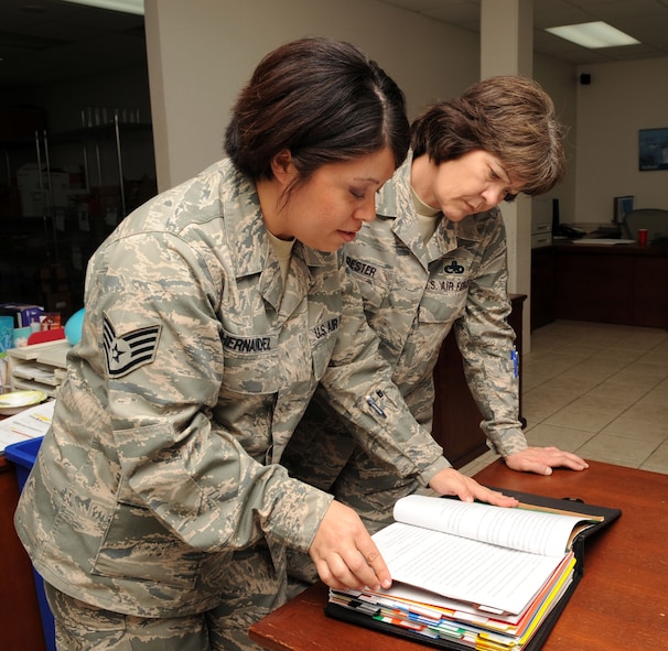 Chief Master Sgt. Carolyn Forester, 2d Maintenance Group quality assurance superintendent, looks over a technical data update  with Staff Sgt. Lina Fernandez, 2d MXG, non commissioned officer in charge of technical order distribution office, to become up-to-speed on new technology data coming out for safety reasons March 10. (U.S. photo by Airman 1st Class Brittany Y. Bateman)(RELEASED)