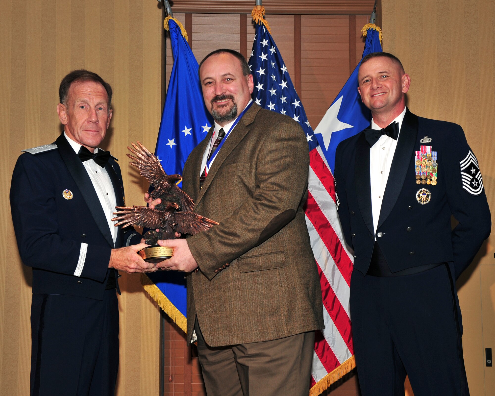 DAVIS MONTHAN AIR FORCE BASE, Ariz. -- William C. Russell, 366th Logistics Readiness Squadron vehicle management and analysis manager, receives the Twelfth Air Force 2009 Outstanding Performer of the Year award in the Intermediate Civilian category March 11. Gunfighters took three of the nine awards. (U.S. Air Force photo)